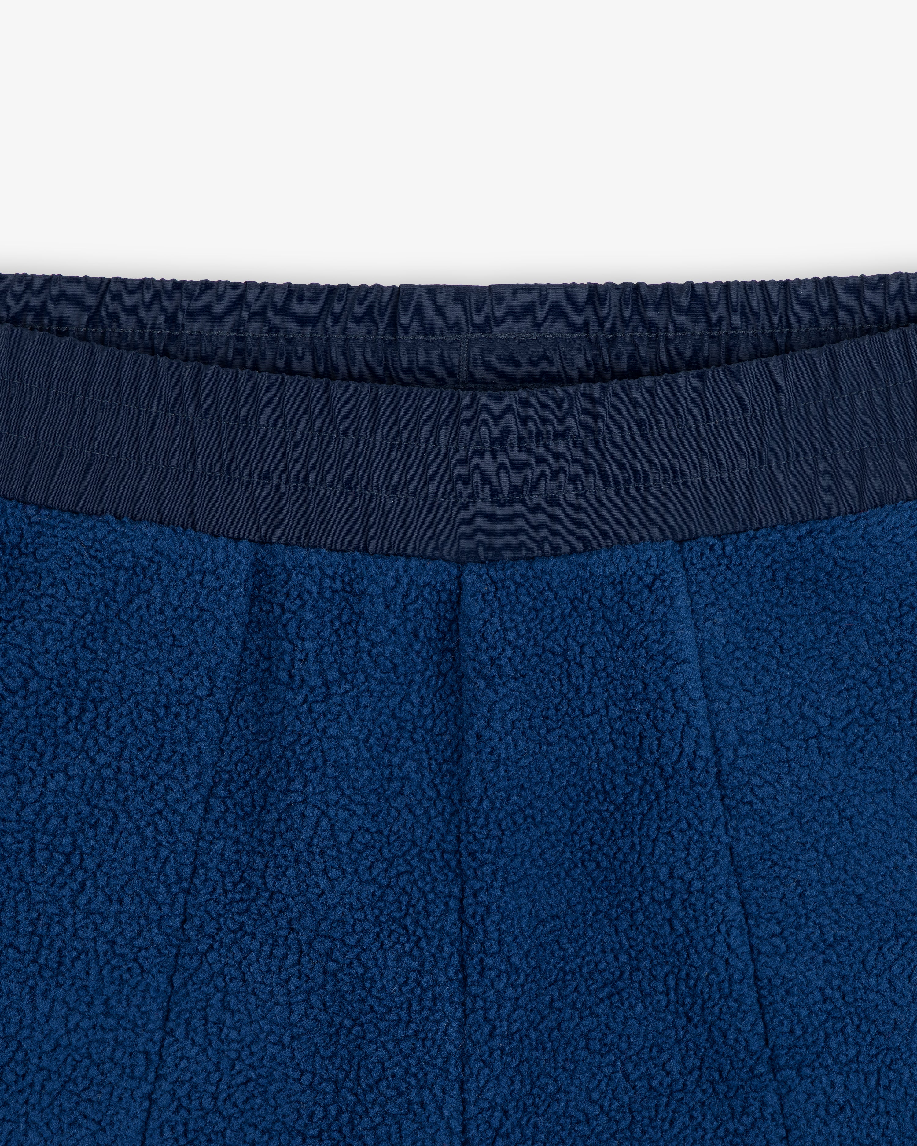 Close-up of ALD / The North Face Denali Fleece Pant’s blue fleece waistband with elastic, texture, and stitching detail.