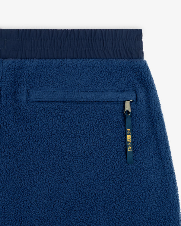 Close-up of ALD / The North Face Denali Fleece Pant with navy waistband and zippered pocket with yellow pull.