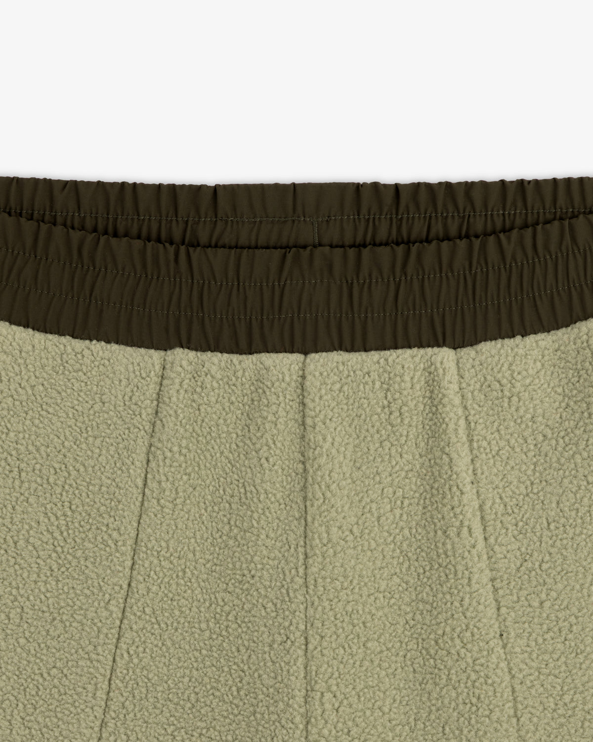 Close-up of ALD / The North Face Denali Fleece Pant with olive green elastic waistband and seam details.
