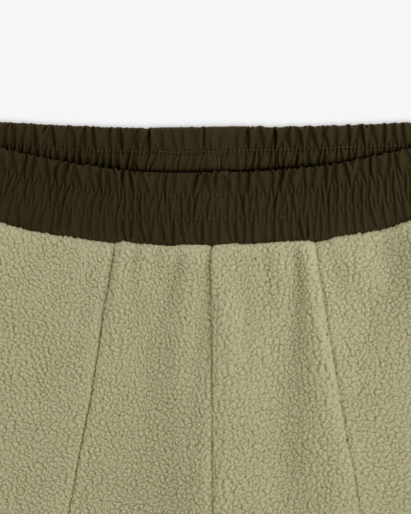 Close-up of ALD / The North Face Denali Fleece Pant with olive green elastic waistband and seam details.