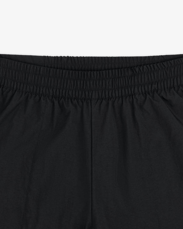 Close-up of ALD / The North Face Nylon Denali Pant, highlighting the elastic waistband, fabric texture, and stitching.