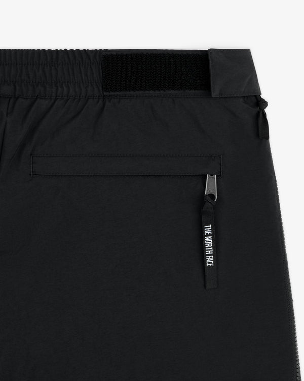 Close-up of ALD / The North Face Nylon Denali Pant with a zippered back pocket and logo on the zipper pull.