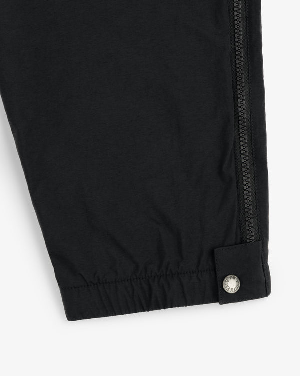 ALD / The North Face Nylon Denali Pant features a black leg with a zipper seam and silver snap by the elastic cuff.