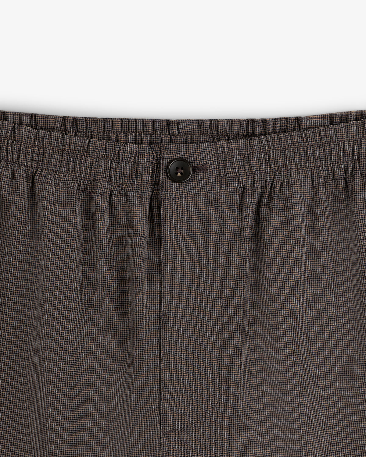 Close-up of Houndstooth Elasticated Waist Trouser featuring button and fly details.
