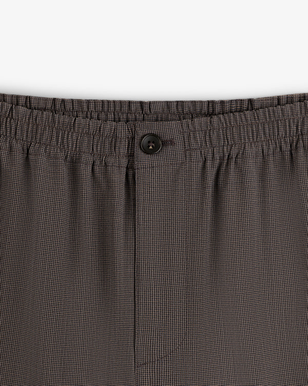 Close-up of Houndstooth Elasticated Waist Trouser featuring button and fly details.