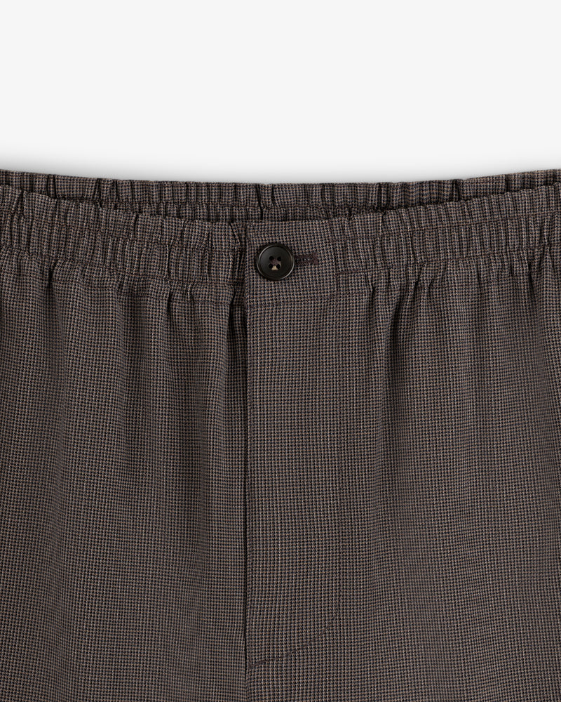 Close-up of Houndstooth Elasticated Waist Trouser featuring button and fly details.