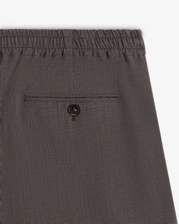 Close-up of Houndstooth Elasticated Waist Trouser with back pocket and button closure.