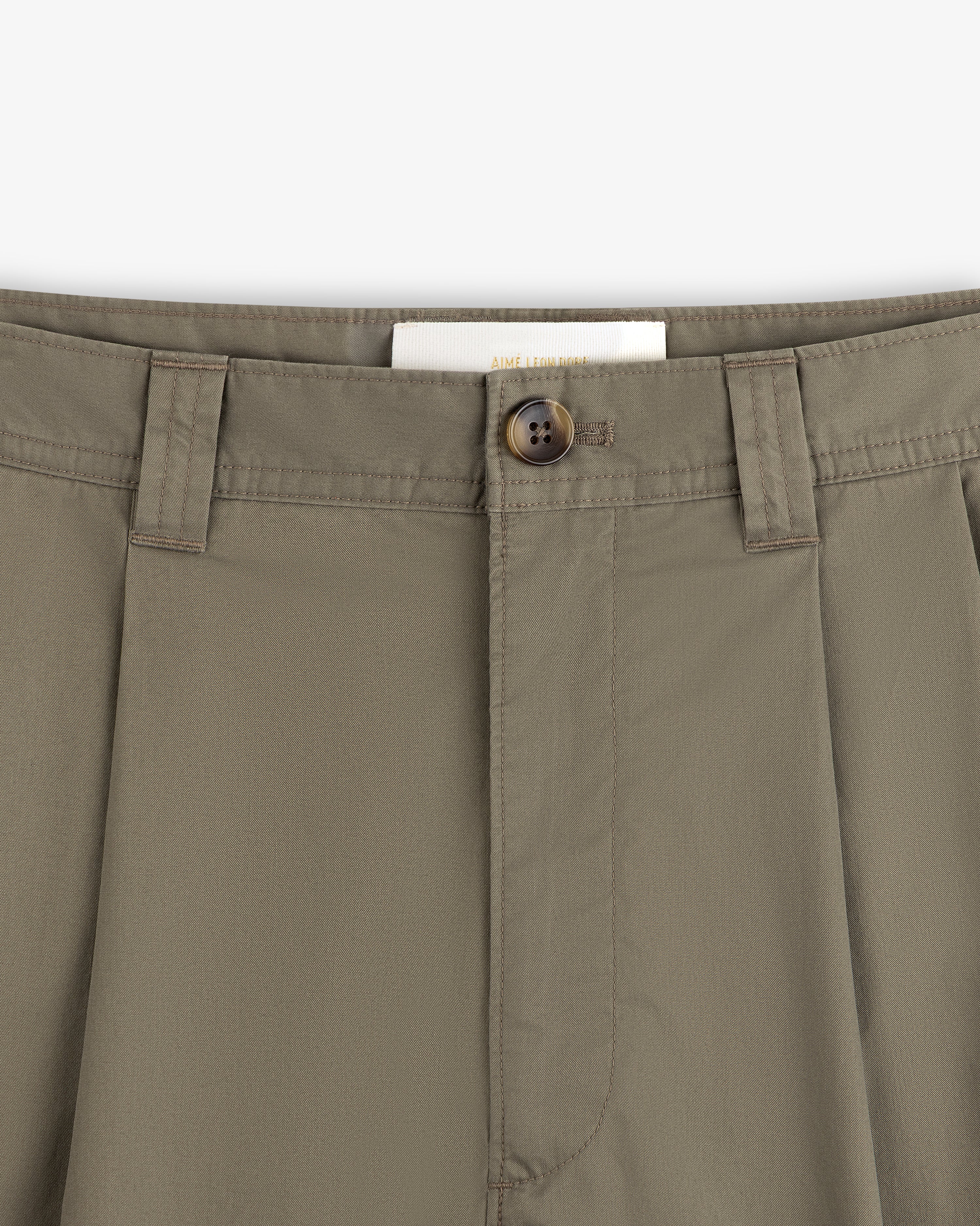 Close-up of Double Pleated Officer Pant waist with belt loops, brown button, and partially visible inside label.