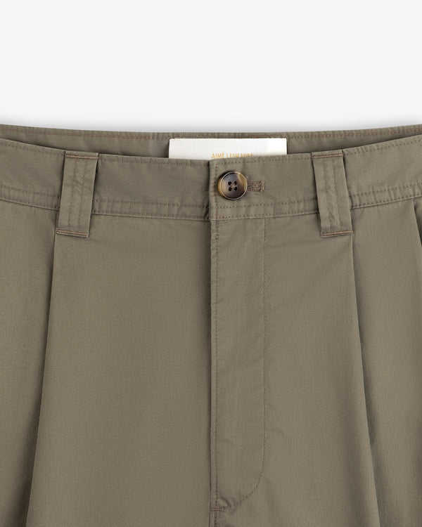 Close-up of Double Pleated Officer Pant waist with belt loops, brown button, and partially visible inside label.