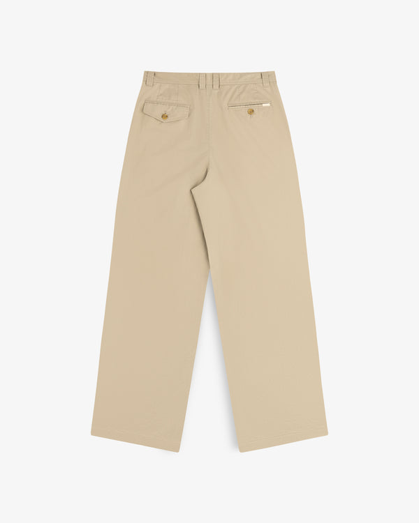 Double Pleated Officer Pant in beige, wide-leg, with two back buttoned pockets and a small white side tag.