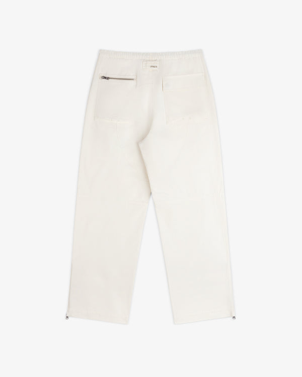 Back view of the Garment Washed Aviator Pant in off-white, featuring a zippered pocket, a flap pocket, and leg zippers.