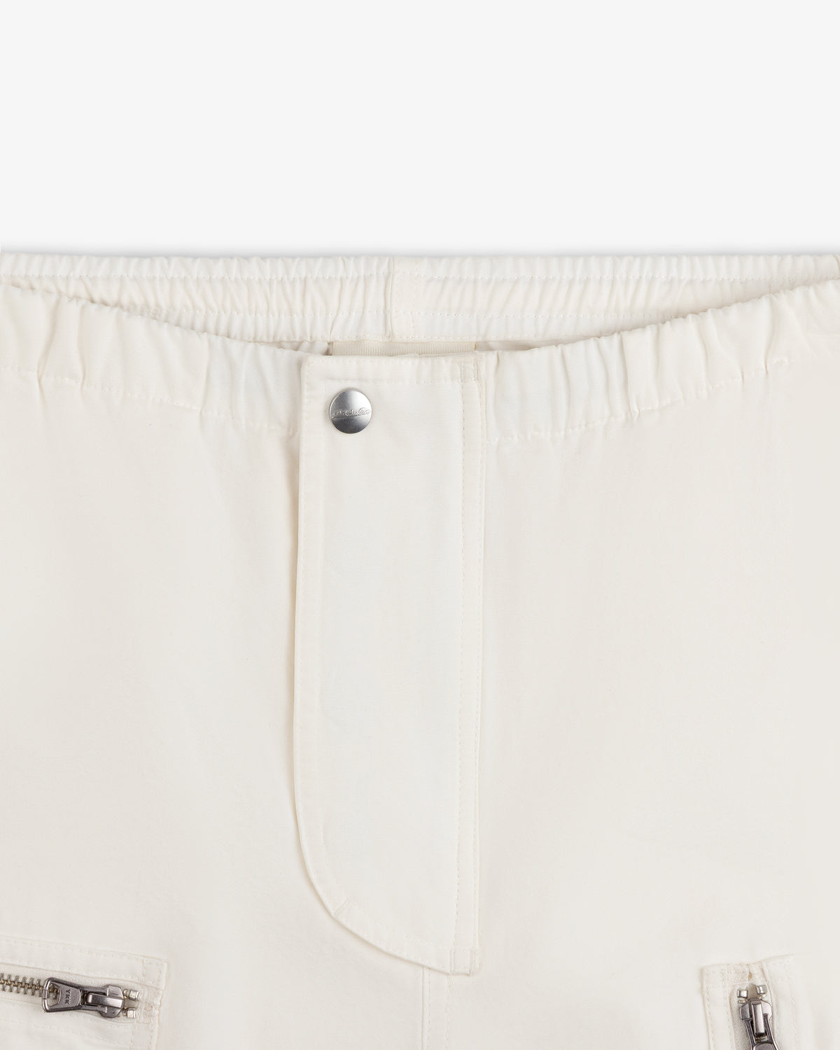Garment Washed Aviator Pants in off-white with an elasticized waistband, center button closure, and zippered pockets.