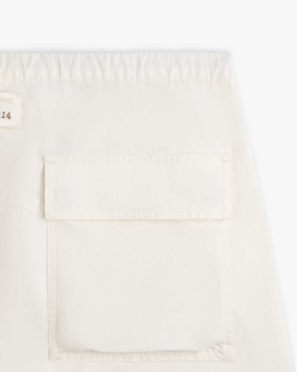 Garment Washed Aviator Pants in off-white with an elastic waistband and a large rectangular flap pocket.