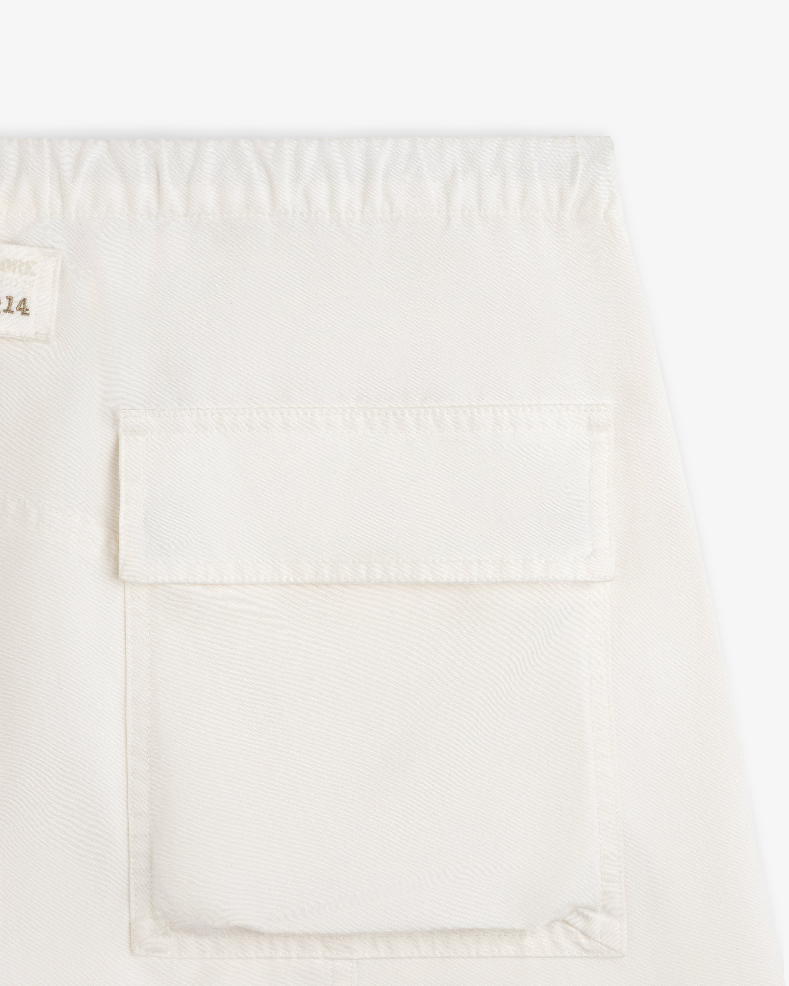 Garment Washed Aviator Pants in off-white with an elastic waistband and a large rectangular flap pocket.