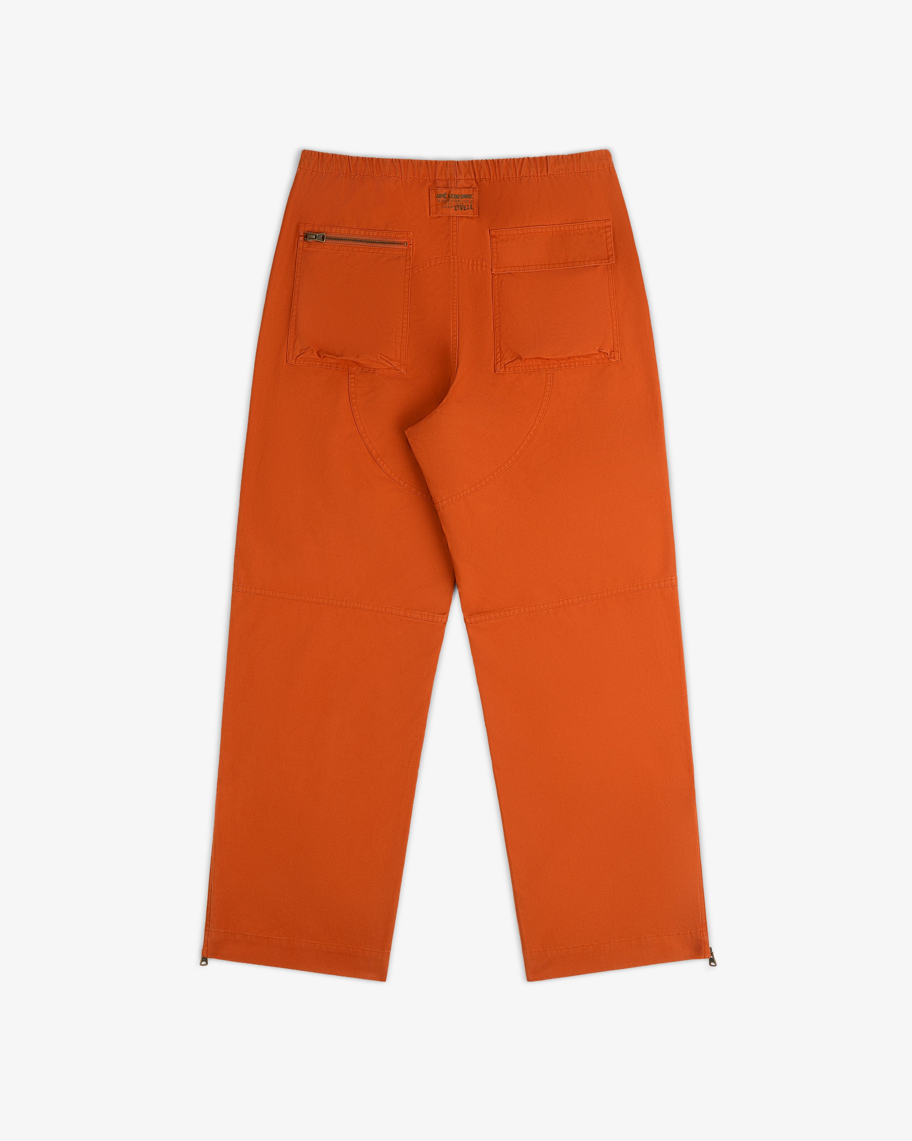 Back view of Garment Washed Aviator Pants in orange with a zippered back pocket and side zippers at the ankles.