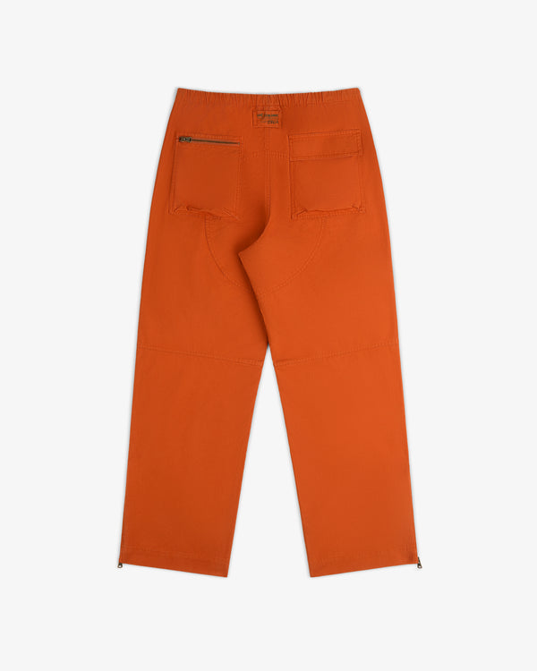 Back view of Garment Washed Aviator Pants in orange with a zippered back pocket and side zippers at the ankles.