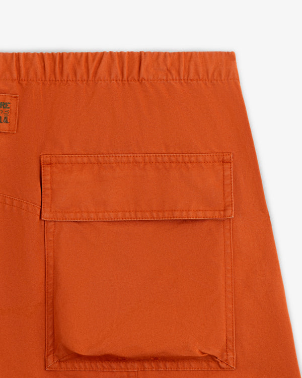 Close-up of the back pocket and elastic waistband of rust-orange Garment Washed Aviator Pant.