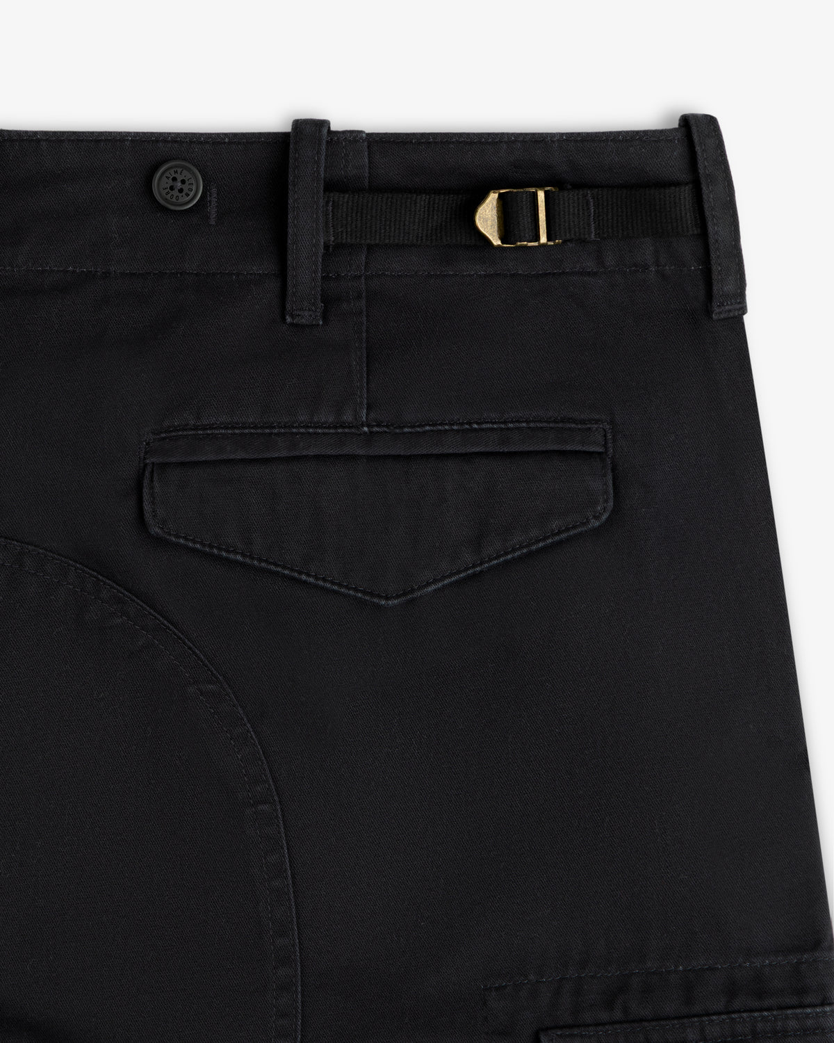 Close-up of Fatigue Pant in black featuring a flap pocket, belt loop, button, and gold buckle at the waistband.