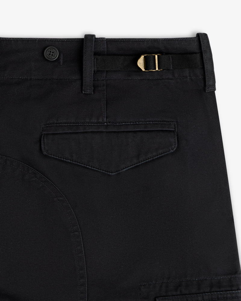 Close-up of Fatigue Pant in black featuring a flap pocket, belt loop, button, and gold buckle at the waistband.