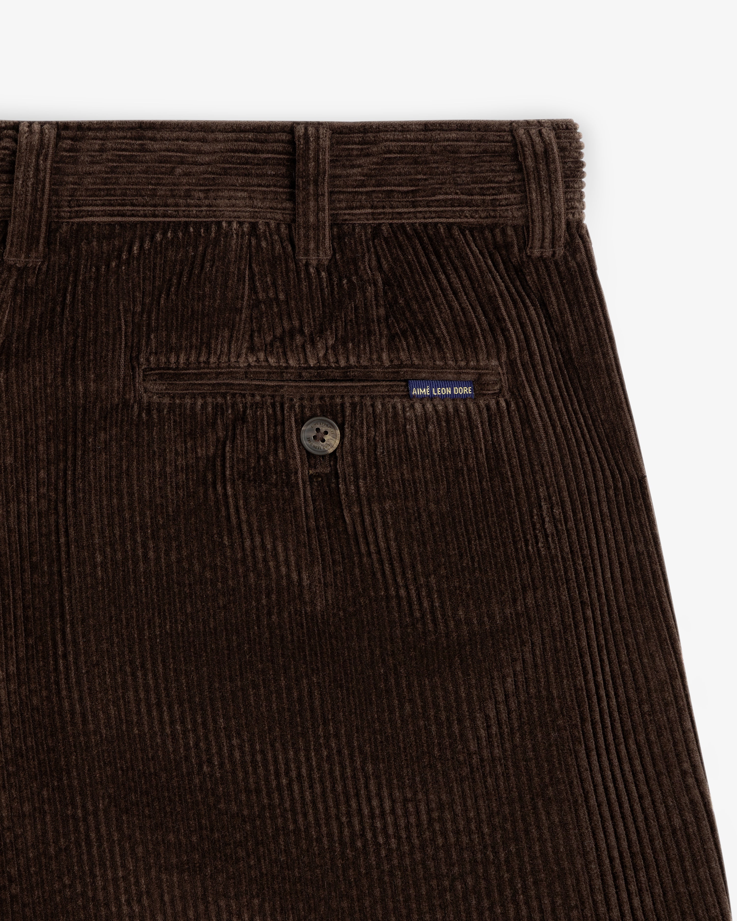 Dark brown Corduroy Trouser showing the back pocket, button closure, and a small brand tag.