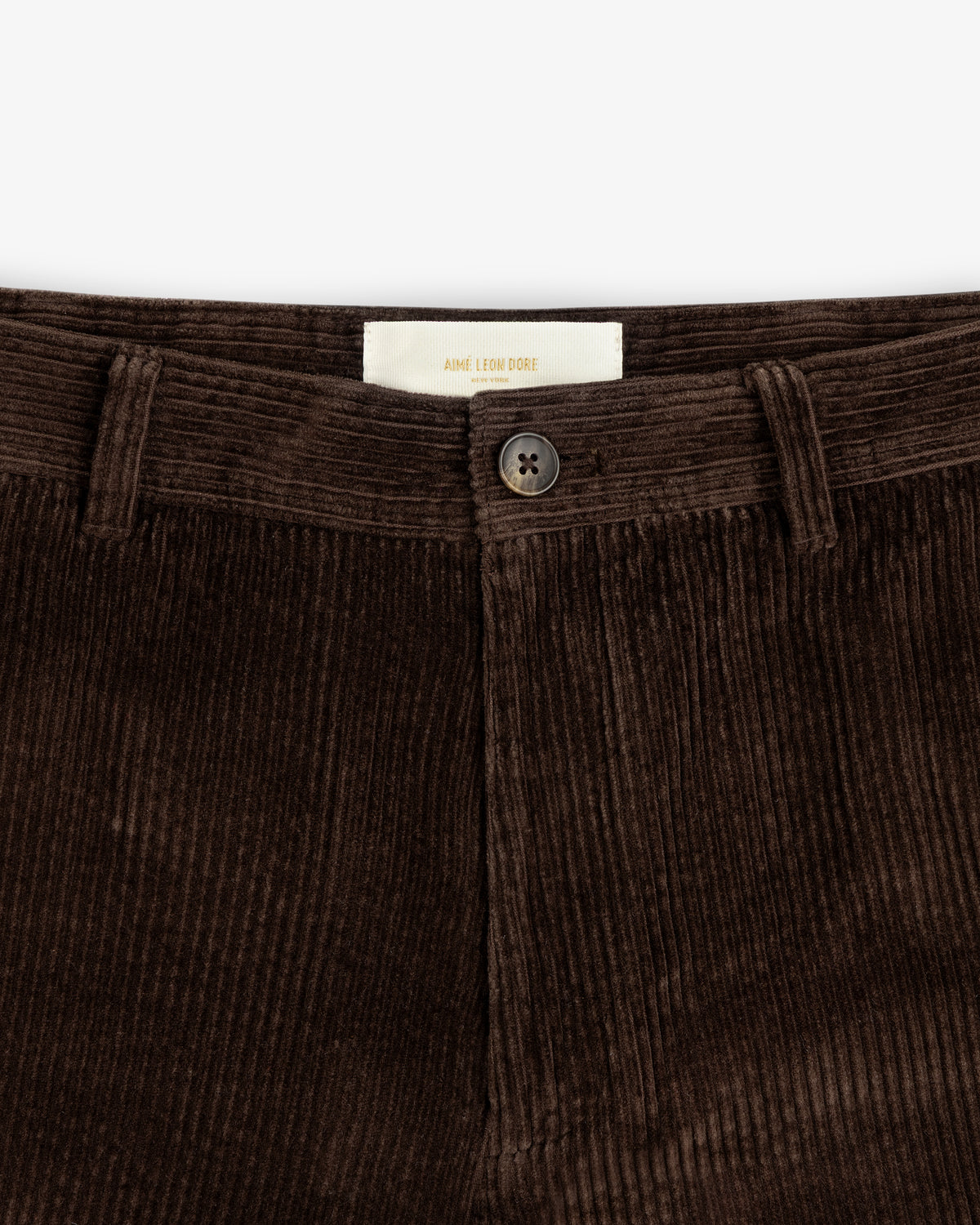 Dark brown Corduroy Trouser with a centered button and interior brand label.