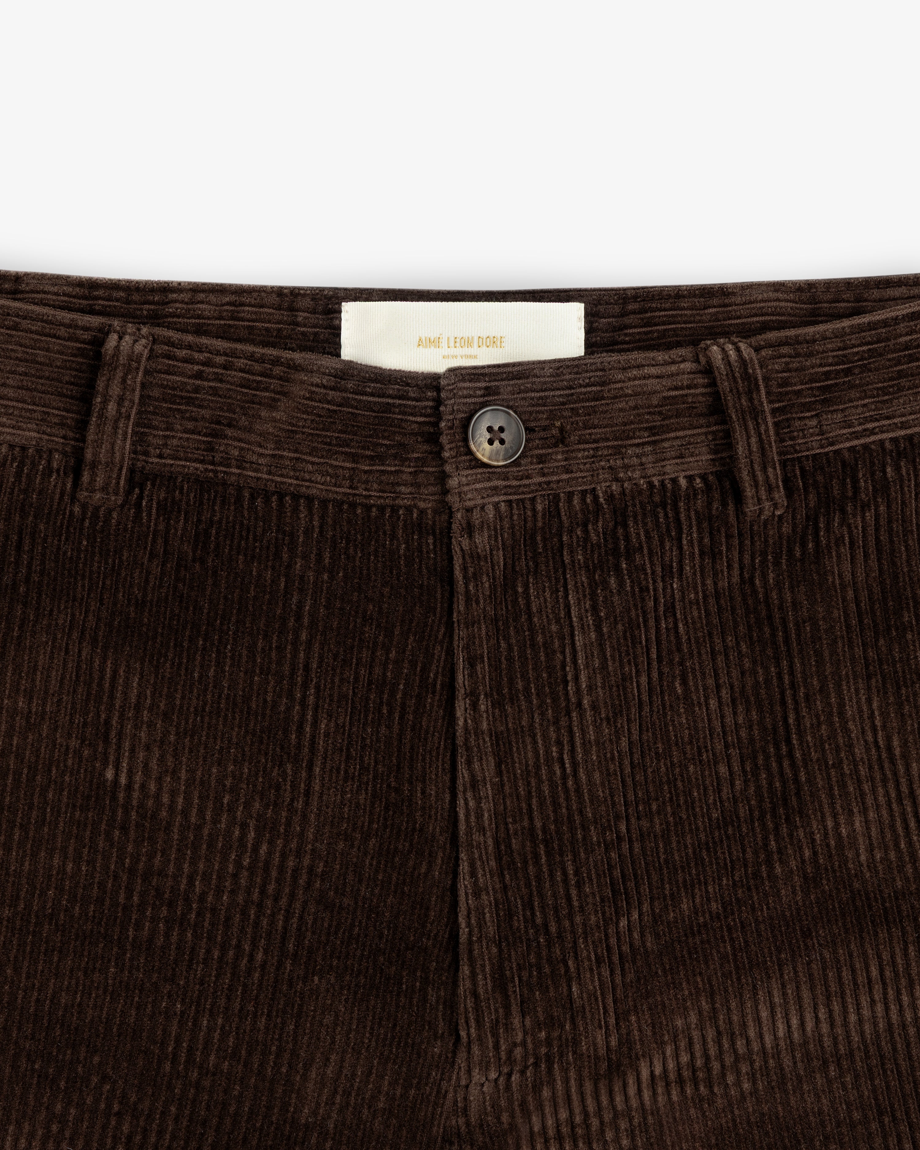 Dark brown Corduroy Trouser with a centered button and interior brand label.