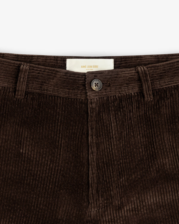 Dark brown Corduroy Trouser with a centered button and interior brand label.