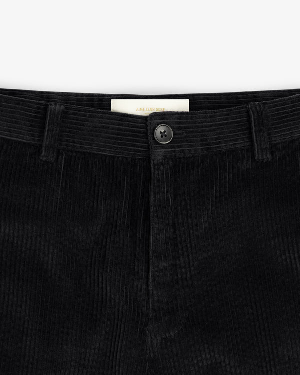 Black Corduroy Trouser with a button fly and a branded interior label.