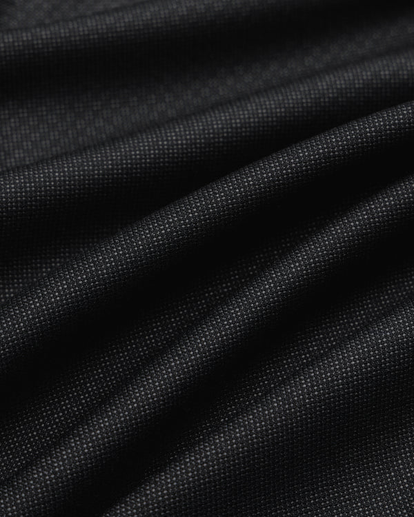 Close-up of black Double Pleated Wool Jacquard Suit Trouser fabric with a fine, textured weave and subtle pleats.