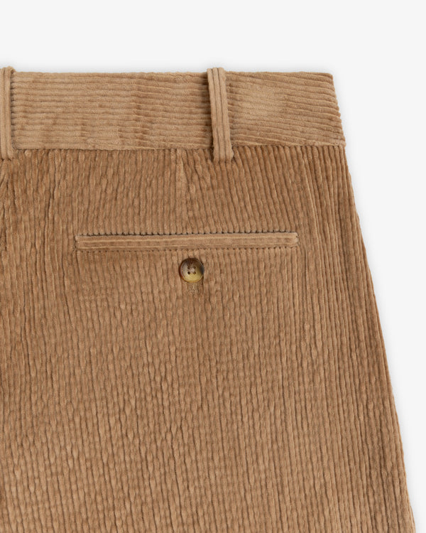 Double Pleated Corduroy Trousers in tan featuring a buttoned back welt pocket and belt loops.