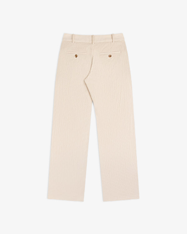 Back view of beige Double Pleated Corduroy Trouser featuring two buttoned welt pockets.