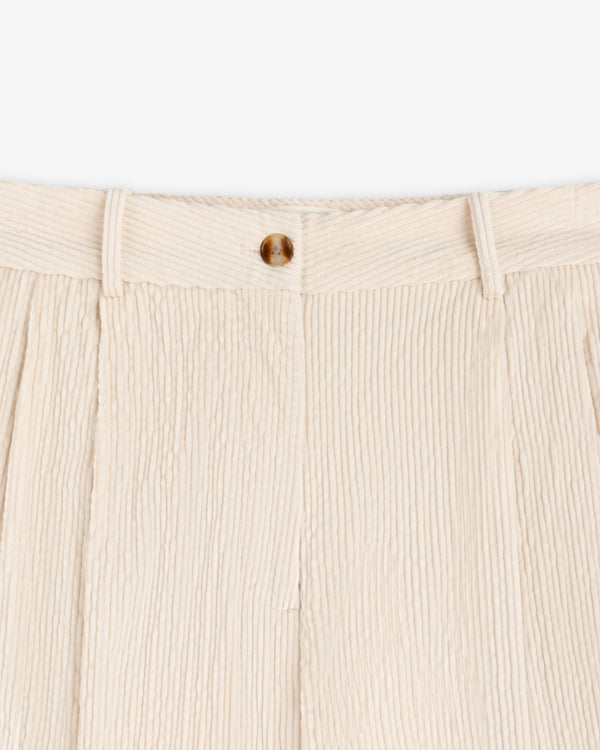 Cream-colored Double Pleated Corduroy Trouser with a pleated front and a single button closure.