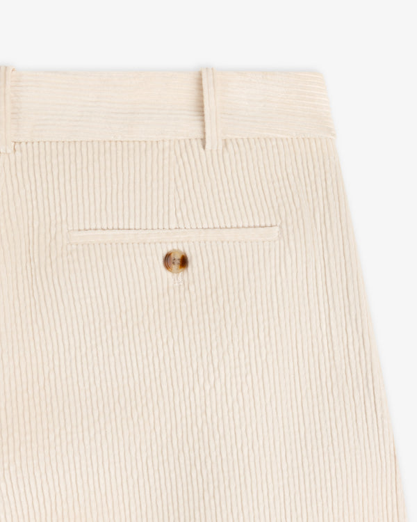 Cream-colored Double Pleated Corduroy Trouser featuring a buttoned back pocket and belt loops.