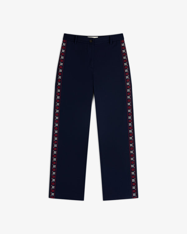 Mani Embroidered Wool Pant in navy blue with a decorative embroidered red and white geometric stripe down the outer seams.