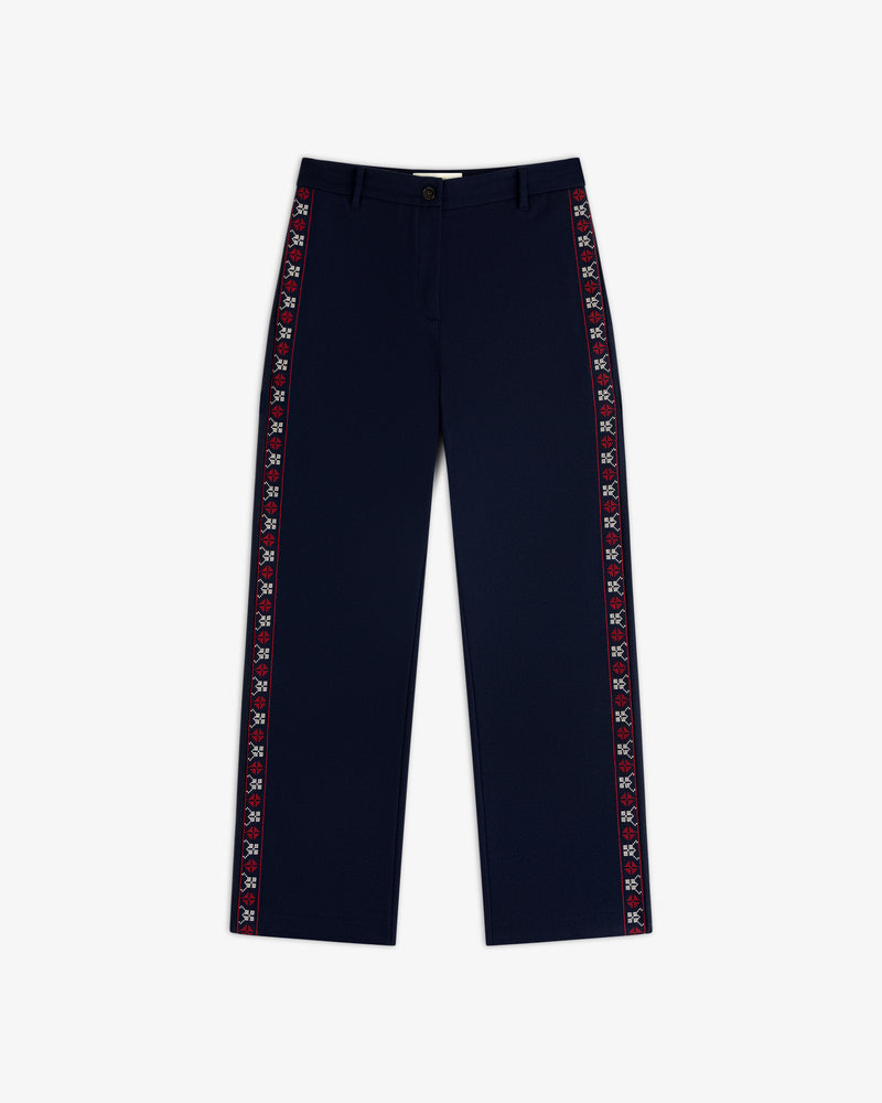 Mani Embroidered Wool Pant in navy blue with a decorative embroidered red and white geometric stripe down the outer seams.