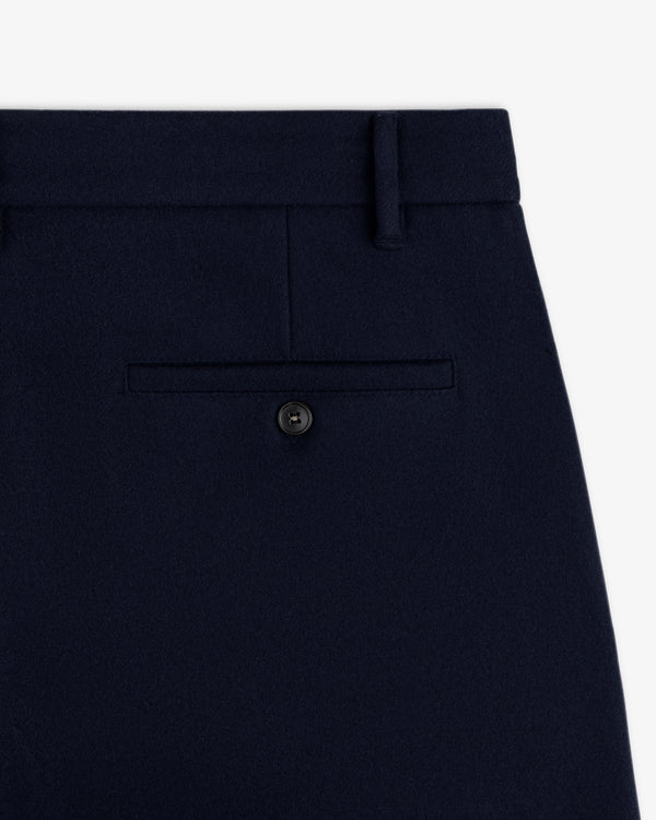 Close-up of Mani Embroidered Wool Pant in navy blue wool, featuring a single rear welt pocket with a button closure.