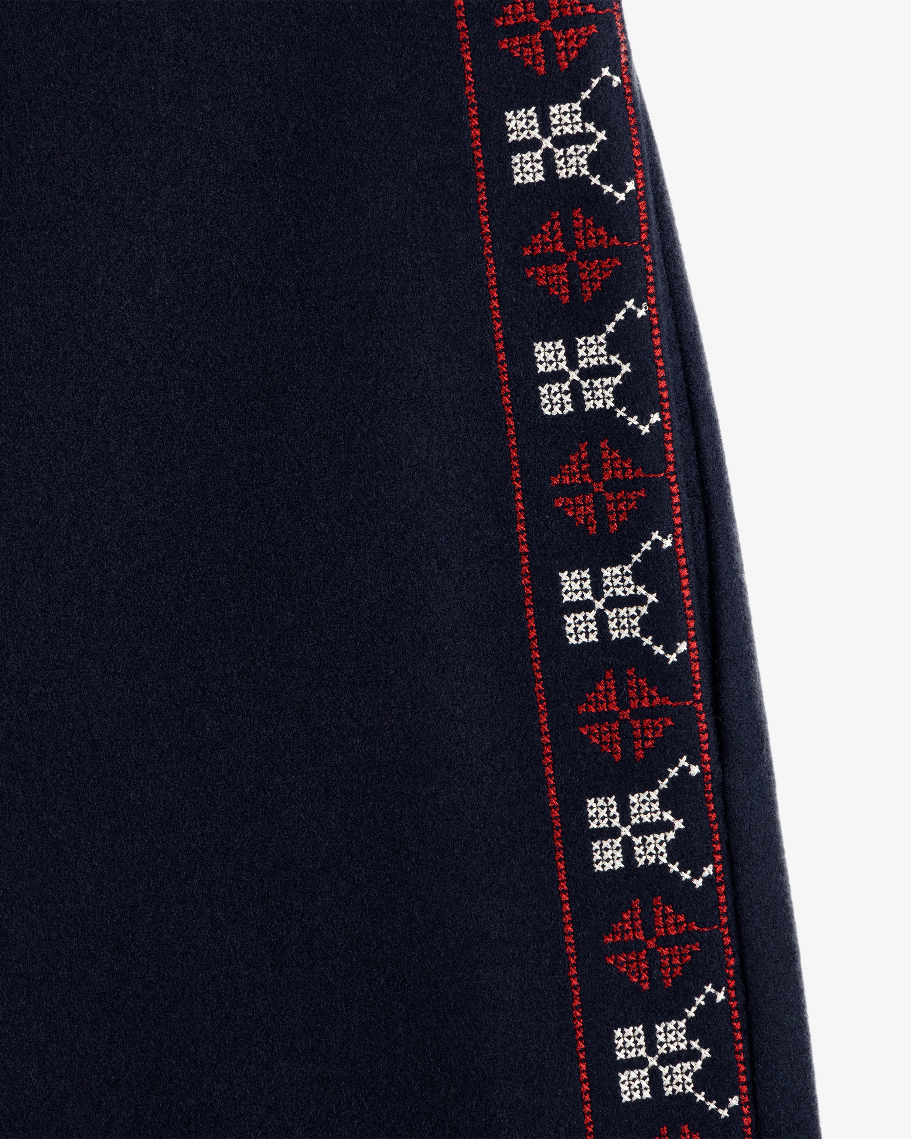 Mani Embroidered Wool Pant in dark navy featuring a vertical side stripe with geometric red and white embroidery.