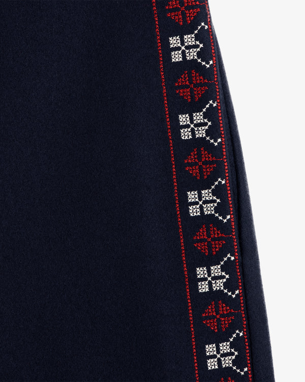 Mani Embroidered Wool Pant in dark navy featuring a vertical side stripe with geometric red and white embroidery.