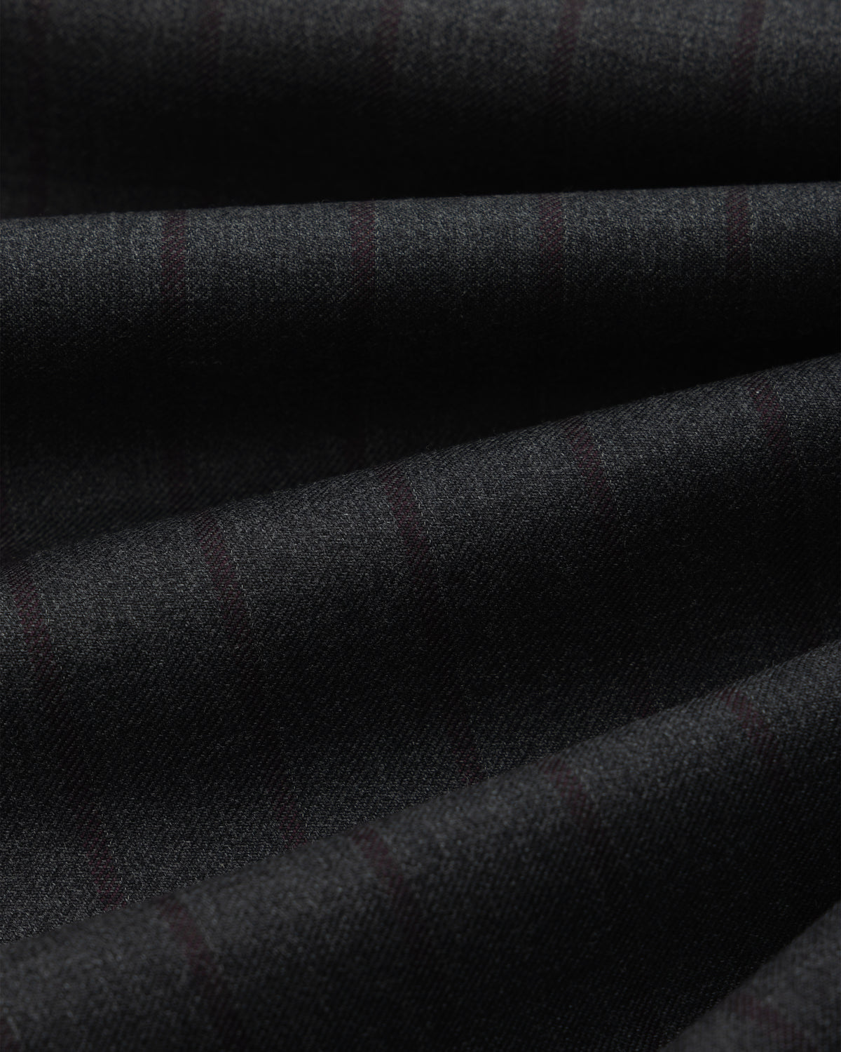 Dark grey Striped Double Pleated Suiting Trouser fabric with faint, thin vertical stripes folded in soft layers.