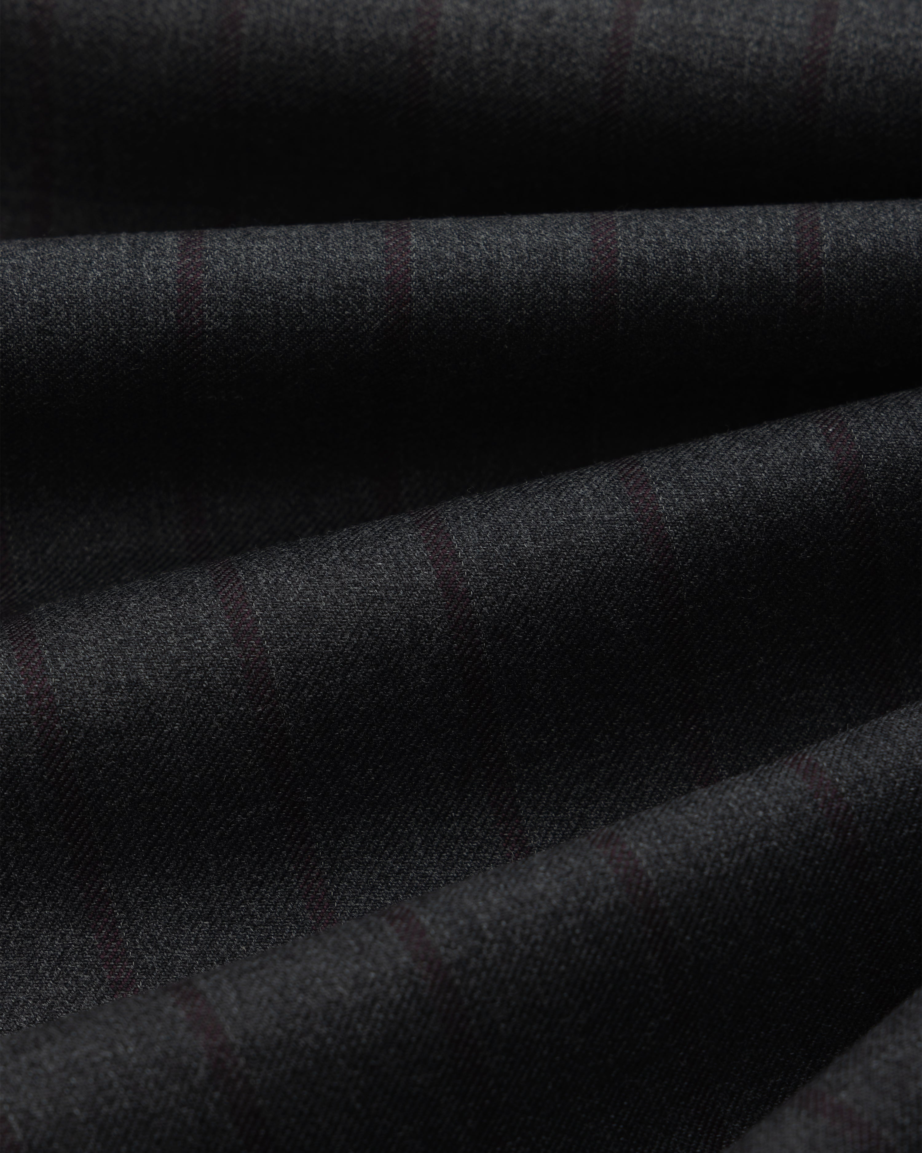 Dark grey Striped Double Pleated Suiting Trouser fabric with faint, thin vertical stripes folded in soft layers.