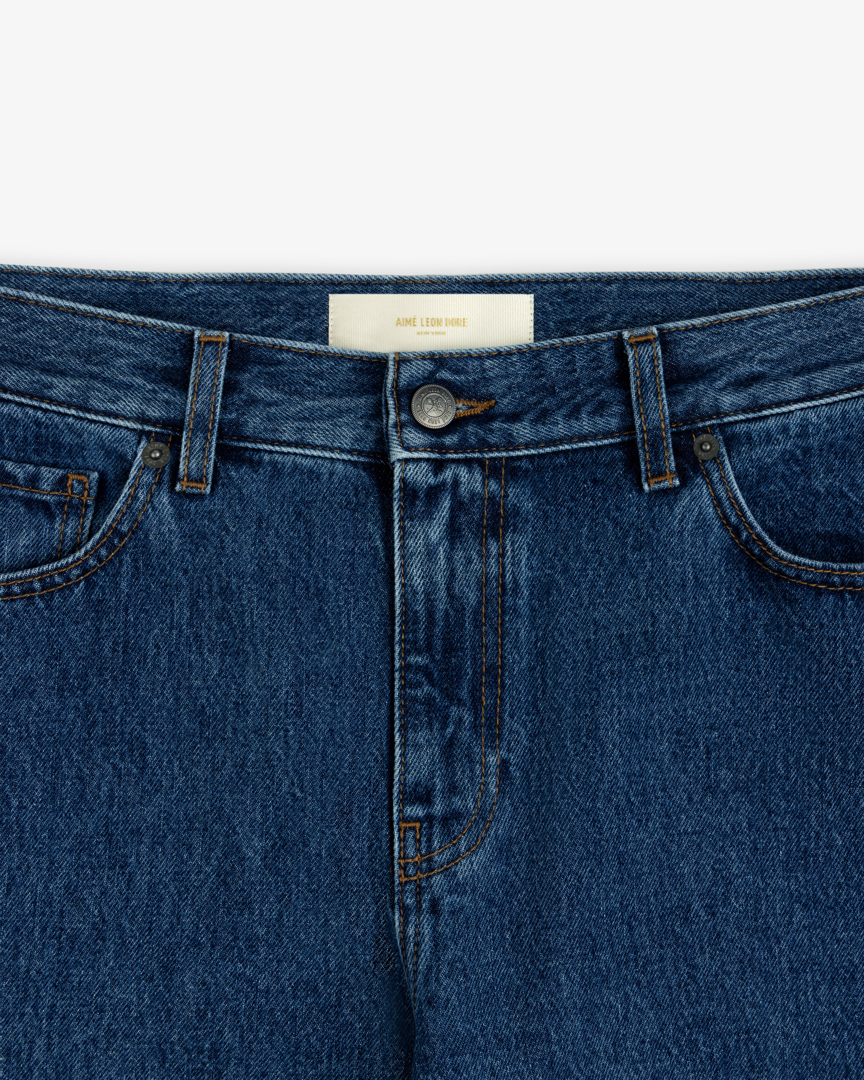 Close-up of the waistband and button fly of dark blue ALD Relaxed Fit Denim jeans.