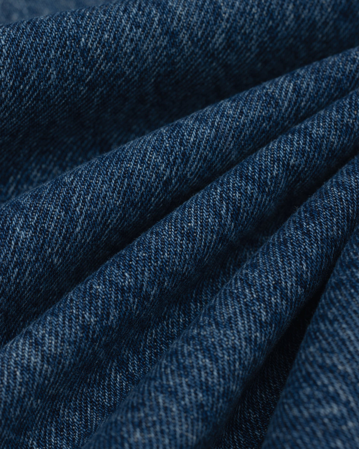 Close-up view of folded dark blue ALD Relaxed Fit Denim fabric.