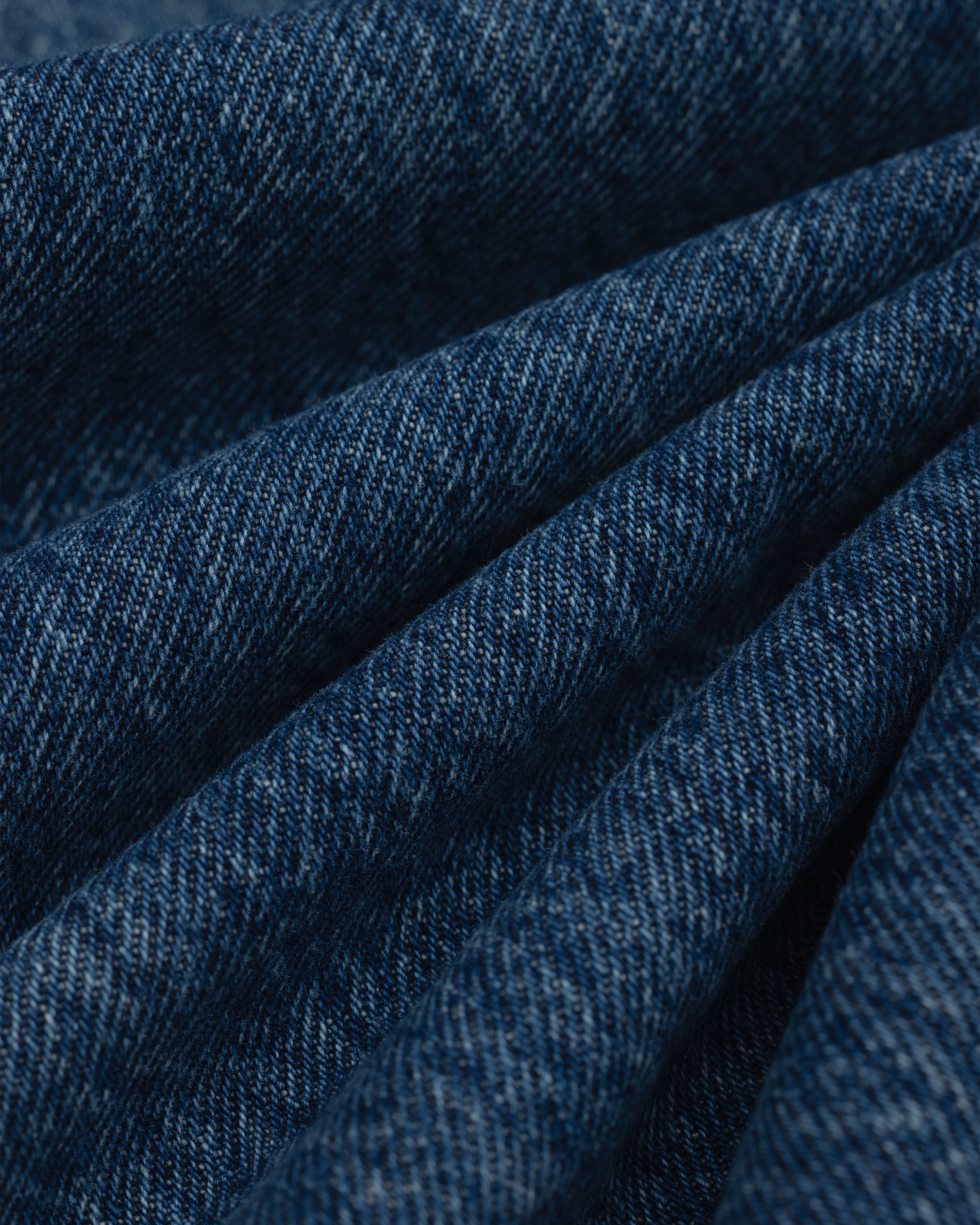 Close-up view of folded dark blue ALD Relaxed Fit Denim fabric.
