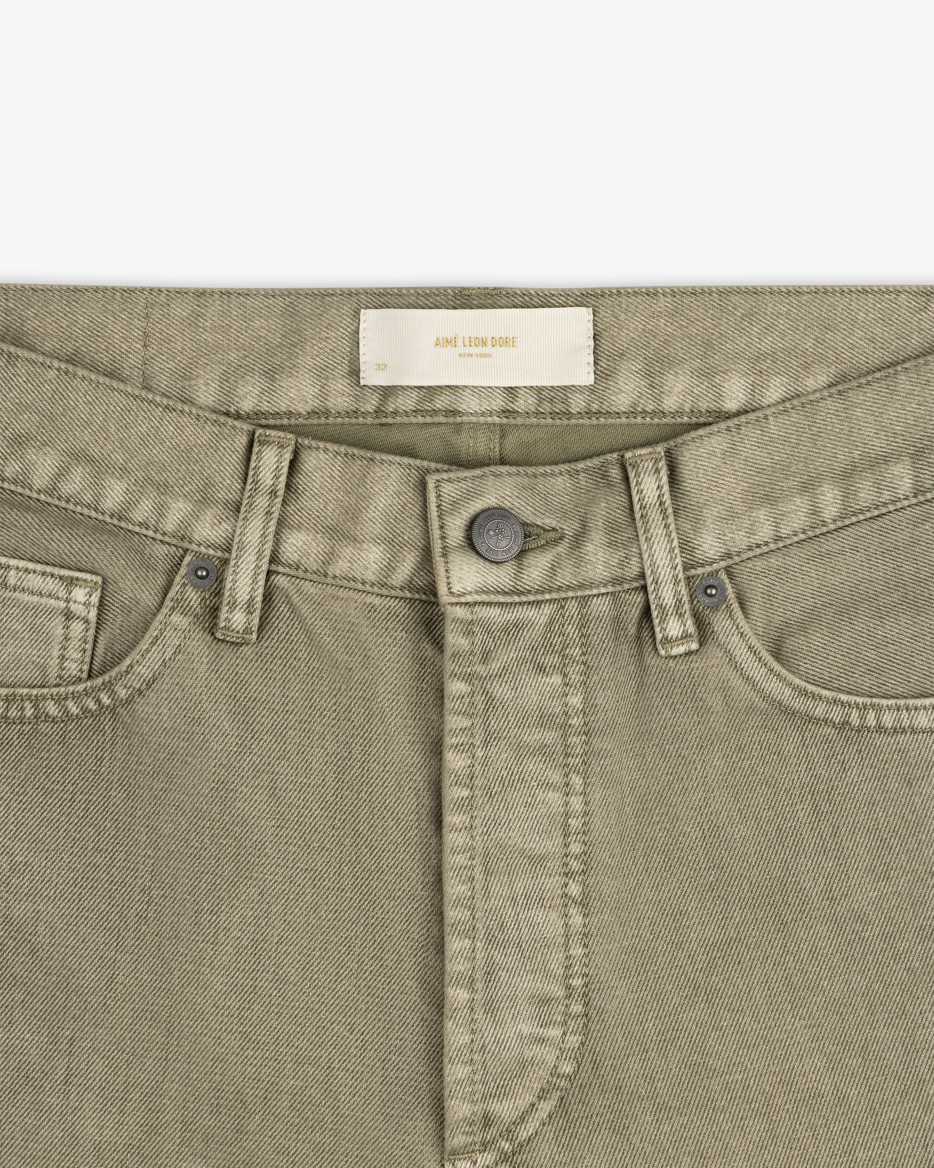 Flocked Straight Fit Denim pants in olive green with a button fly and a label at the waistband.