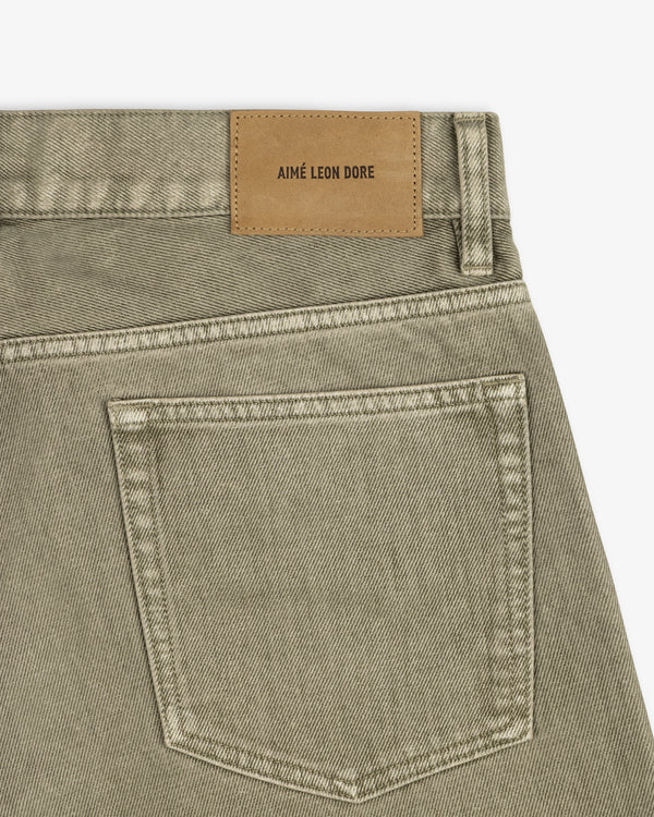 Olive-colored Flocked Straight Fit Denim jeans with a tan leather brand patch on the back waistband.