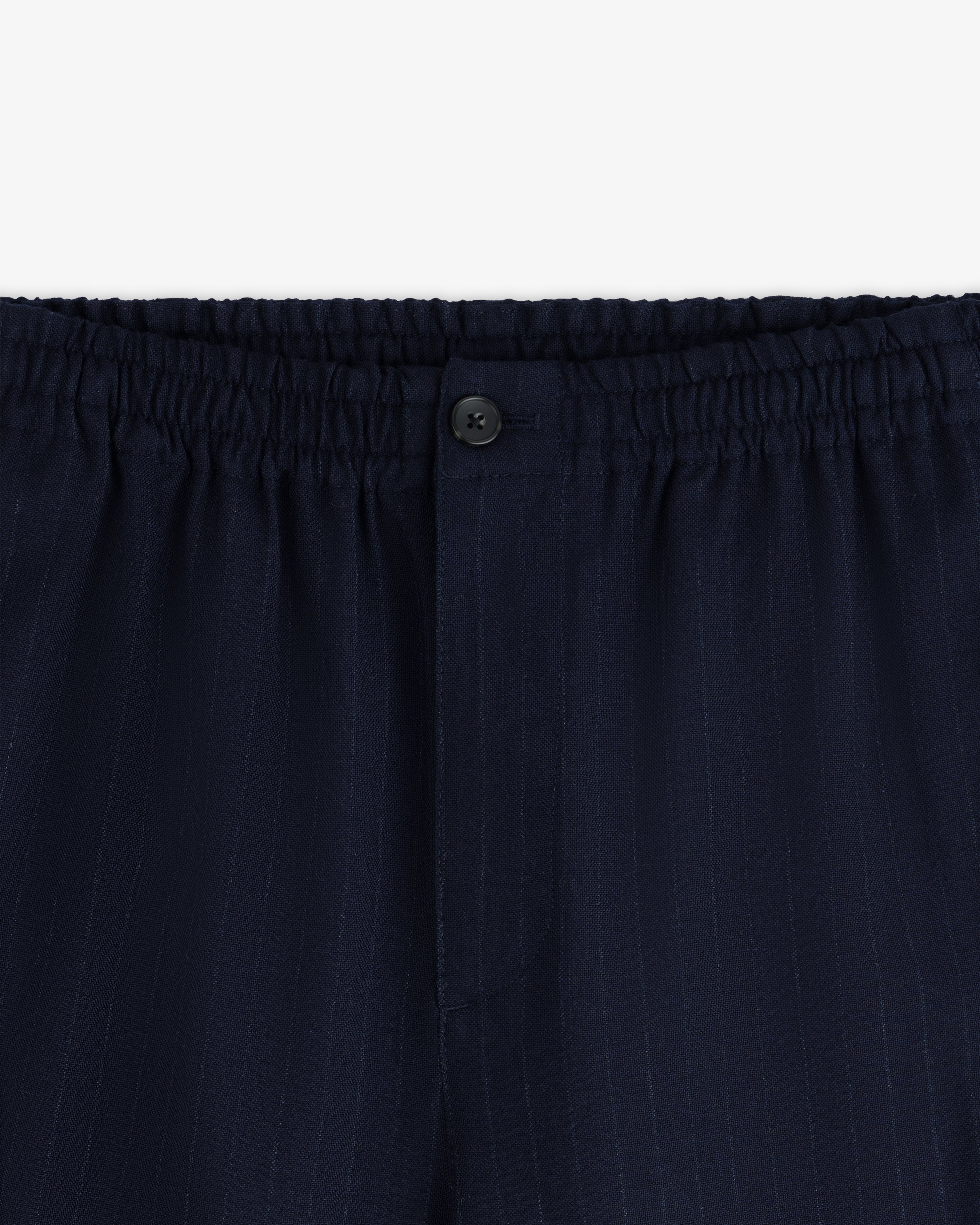 Wool Chalk Stripe Elasticated Waist Trouser in dark navy with an elasticated waistband and a single button closure.