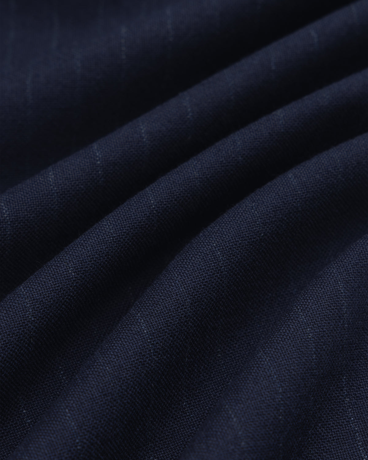 Wool Chalk Stripe Elasticated Waist Trouser in dark blue fabric with subtle vertical chalk stripes, shown in soft folds.