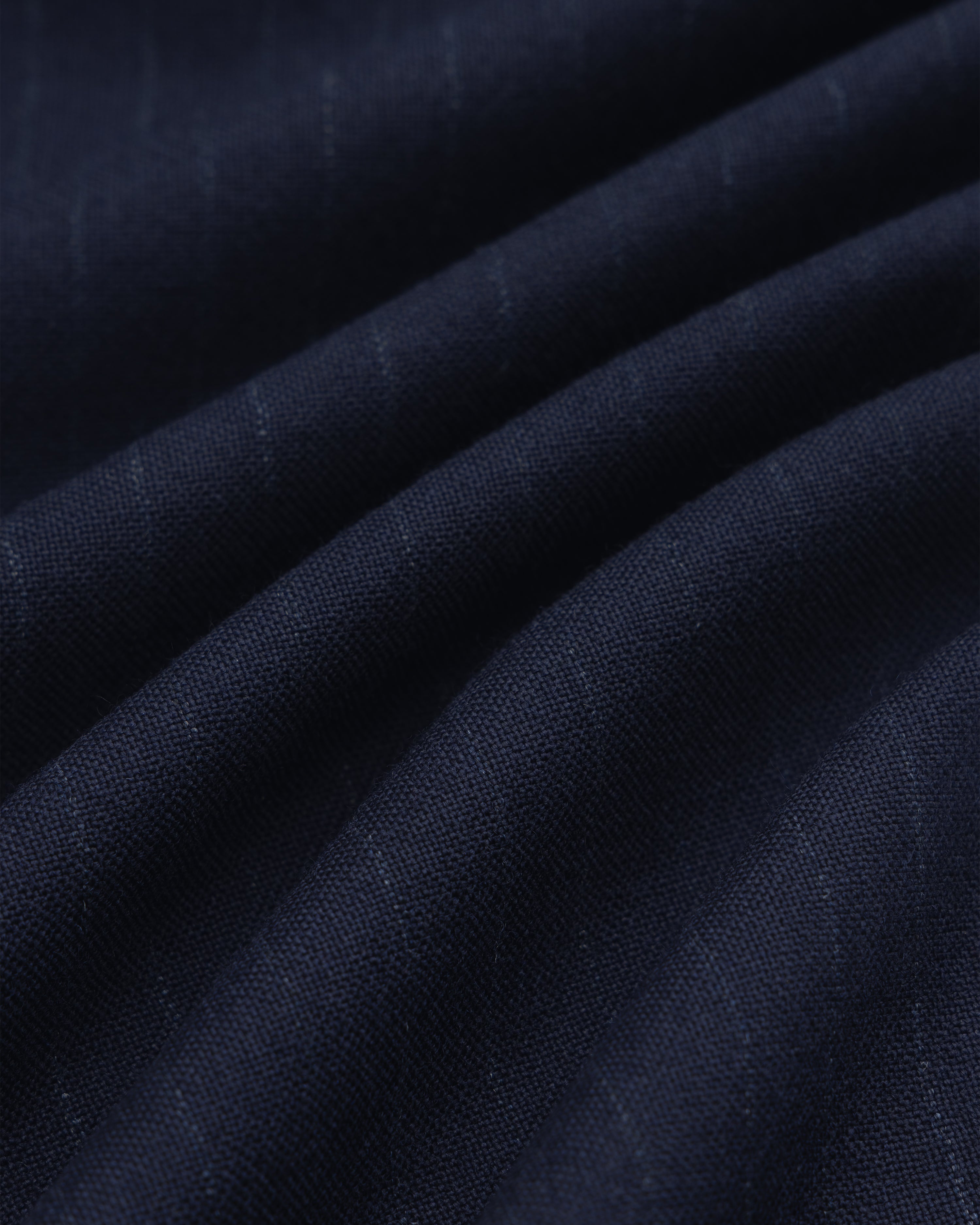 Wool Chalk Stripe Elasticated Waist Trouser in dark blue fabric with subtle vertical chalk stripes, shown in soft folds.