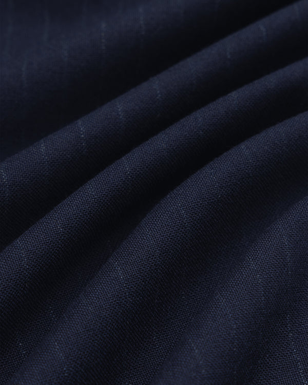 Wool Chalk Stripe Elasticated Waist Trouser in dark blue fabric with subtle vertical chalk stripes, shown in soft folds.