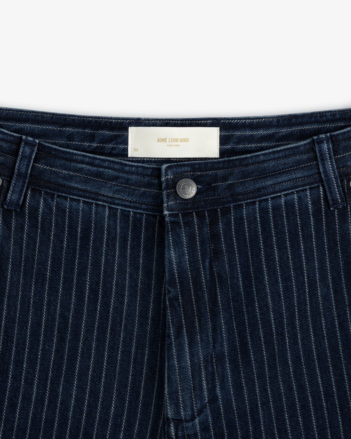 Close-up of the waist and fly of Chalk Stripe Painter Pant with a metal button and belt loops.